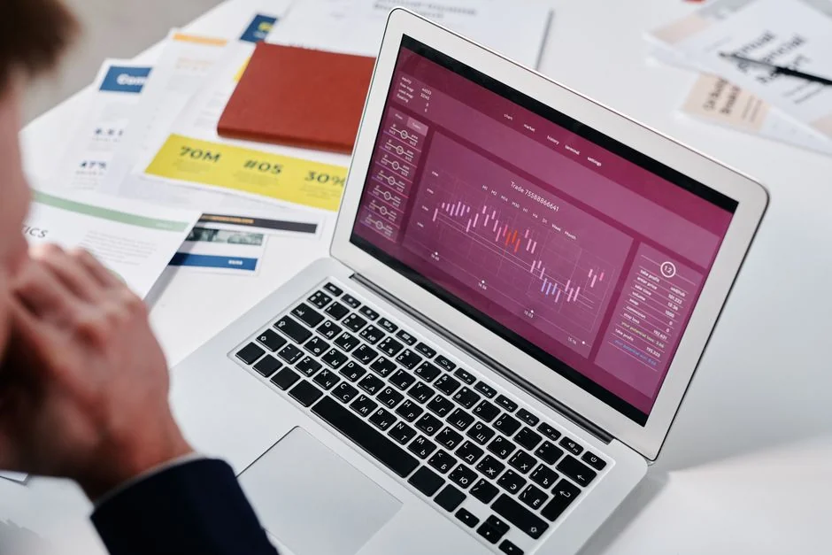 Team reviewing financial charts and digital data on tablets in an office setting.
